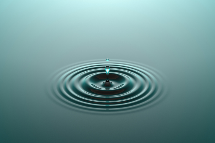 Purpose Create a Ripple: Water drop or rain drop falling on water surface. Liquid ripple splash in sunlight with reflection.